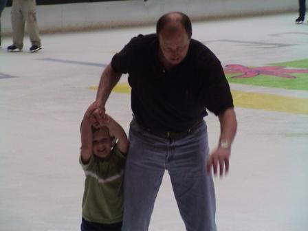 Uncle trying to stay upright while keeping keep Kevin from falling.