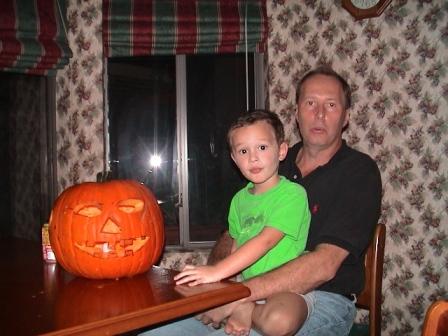 Kevin and Uncle making a Jack-o-lantern.  What messy fun!
