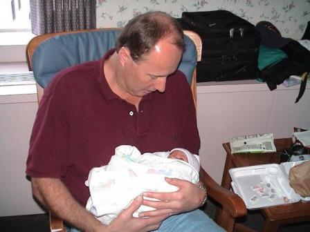 Uncle rocking Kelsi and letting her know what fun they are going to have.