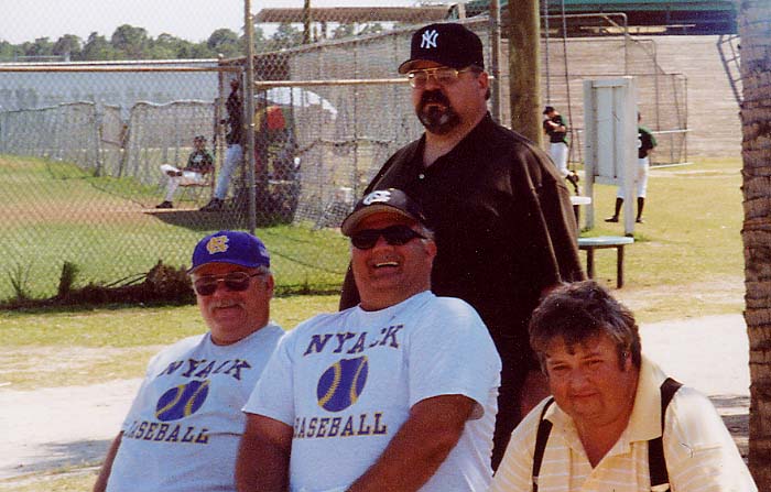 DADDY for those that dont know is the man sitting in the bottom right in the yellow shirt. these are the baseball dads in flordia 2002 watching their sons play