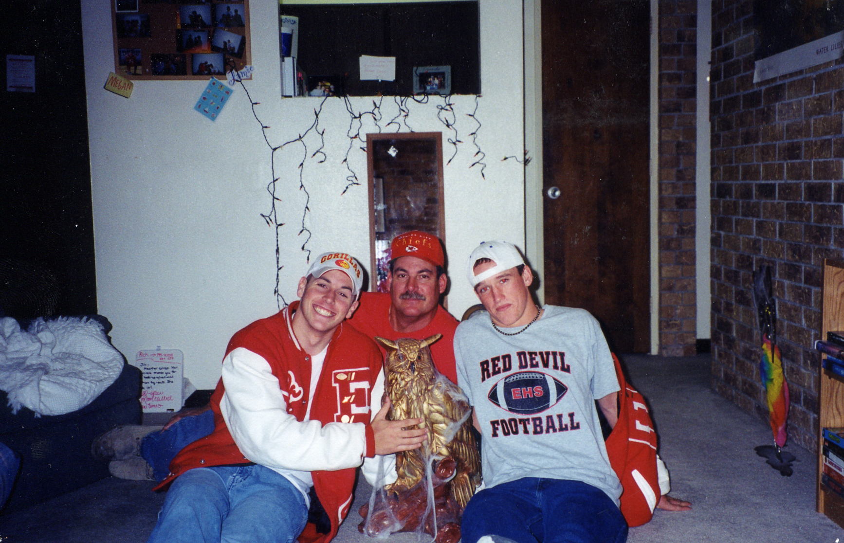 Eric, Derek, and my dad, Terry, posing for a pic at my apt.  before a Chiefs game.  All our guests had their pics taken with "Hooter" & put on our bulletin board. This was always one of our favorites!