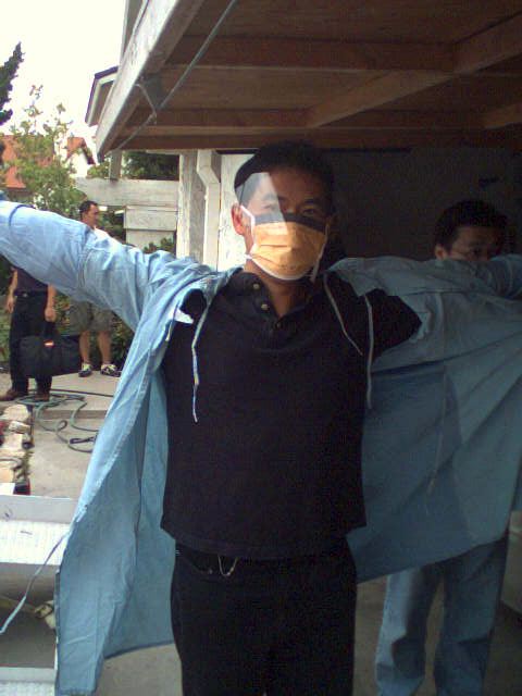 Dr. Yang prepares to give anesthesia; actually he is getting ready to battle in a paintball game.