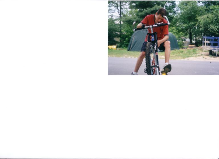 Nick riding his bike during the summertime.